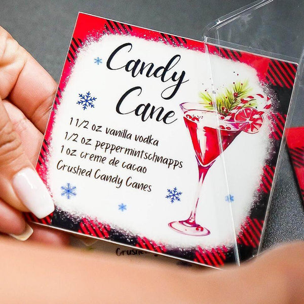 Hands holding UV DTF stickers for a festive drink recipe, showcasing vibrant colors and design details.