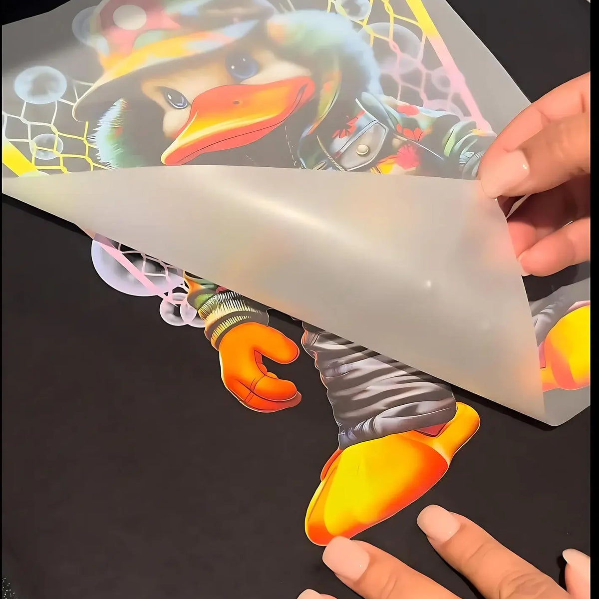 Custom DTF Gang Sheets showcasing a vibrant cartoon duck design being applied to fabric.