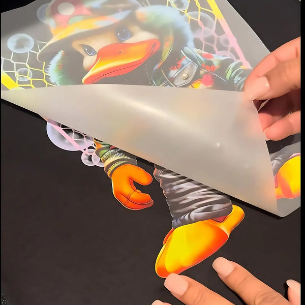 Custom DTF Gang Sheets showcasing a vibrant cartoon duck design being applied to fabric.