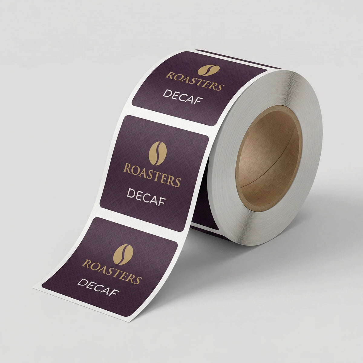Roll of 'Roasters Decaf' labels on a light gray background