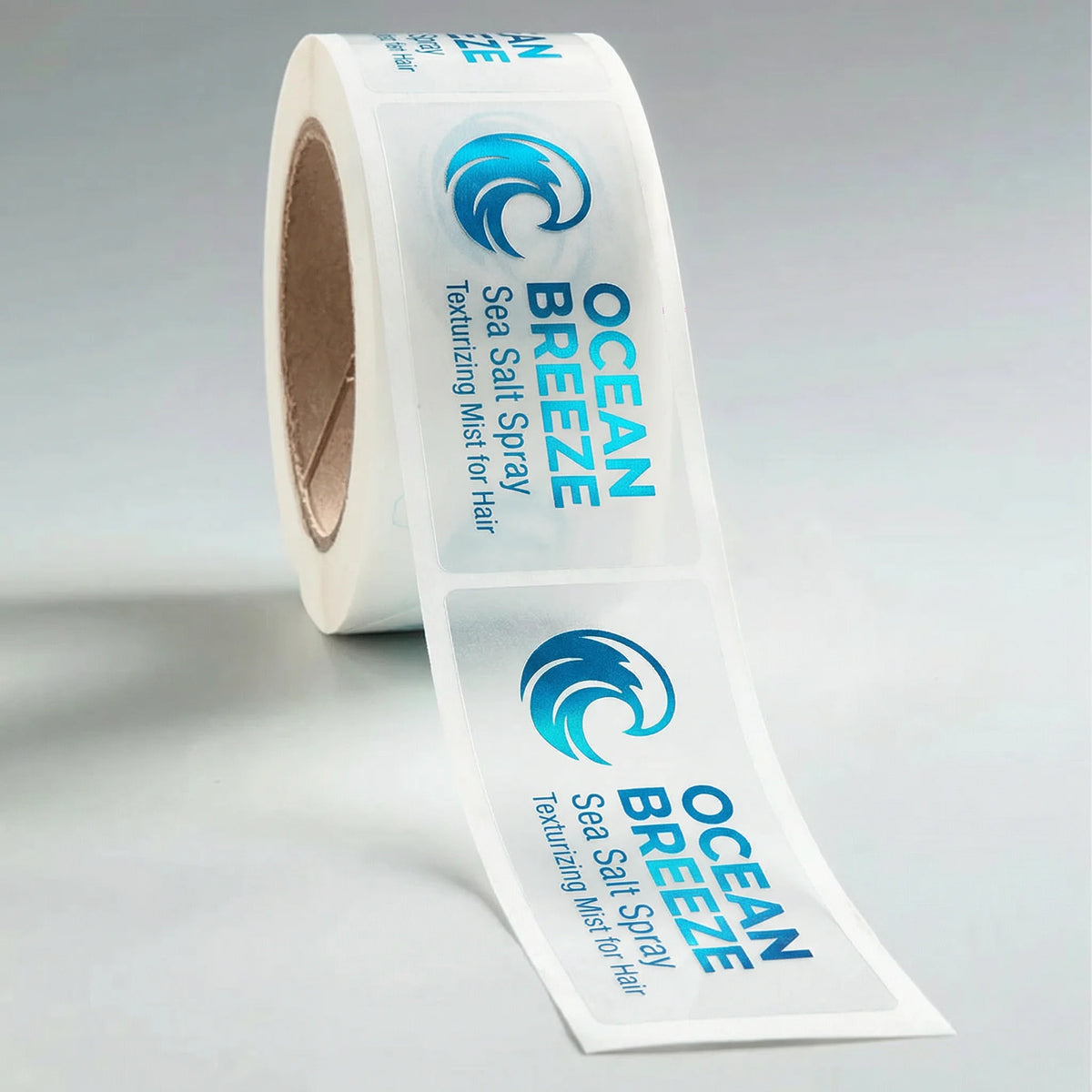 Roll of Ocean Breeze texturizing mist labels on a gray background