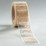 Roll of Alchemy Spirit Mixers labels on a gray background