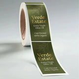 Roll of Verde Estate olive oil labels on a gray background