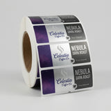 Roll of Celestia Coffee Co. Nebula Dark Roast labels on a gray background