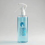 Clear spray bottle labeled 'Ocean Breeze' on a light gray background