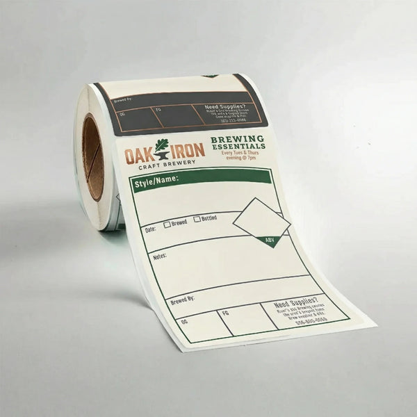 Roll of labels with 'Oak Iron Brewing Essentials' branding on a gray background