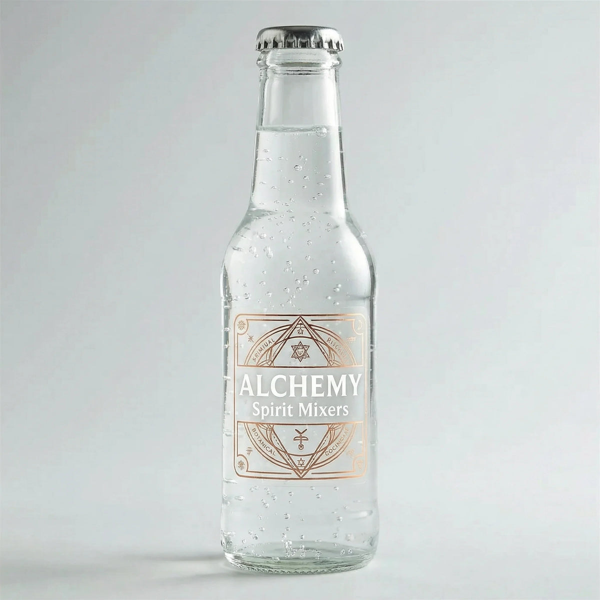 Clear glass bottle of 'Alchemy Spirit Mixers' on a light gray background