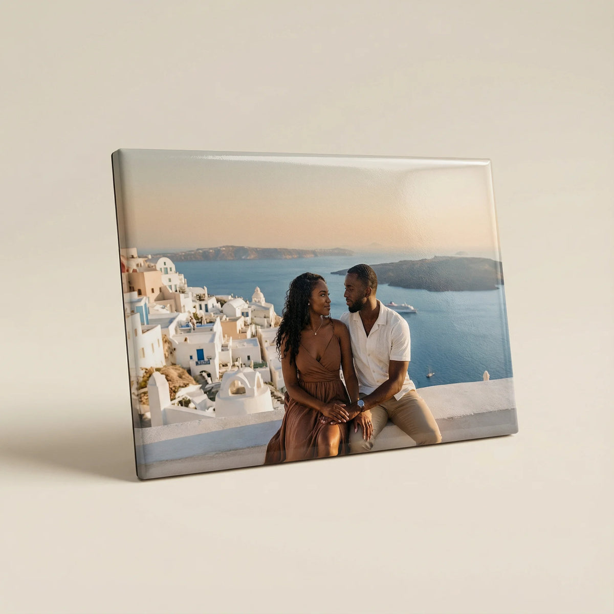 Canvas print of a couple in Santorini with a scenic view.