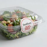 Salad in a clear container with a SealSure label on a light gray background