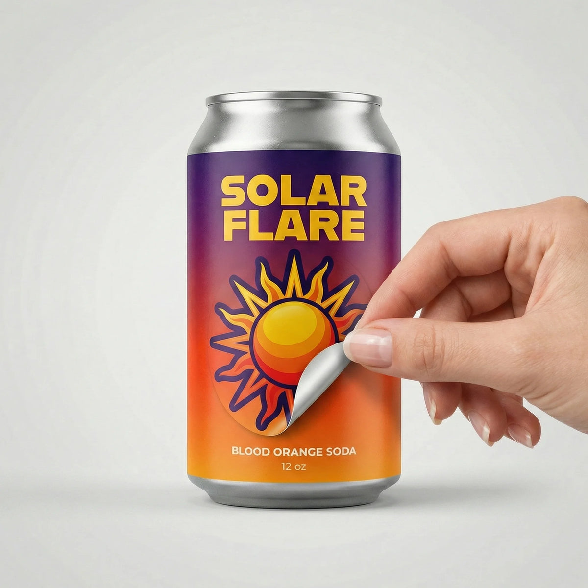 Can of Solar Flare blood orange soda with a hand opening it on a light gray background