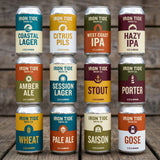 Collection of Iron Tide Brew Co. beer cans on a wooden surface