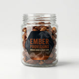 Glass jar with smoked goods labeled 'Ember Provisions' on a white background