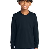 Next Level Apparel ®  Youth Cotton Long Sleeve Tee NL3311 worn by a smiling boy in a dark color.