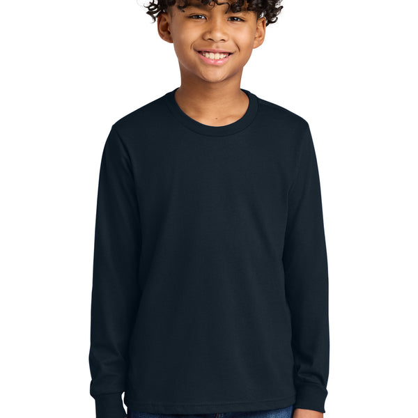 Next Level Apparel ®  Youth Cotton Long Sleeve Tee NL3311 worn by a smiling boy in a dark color.