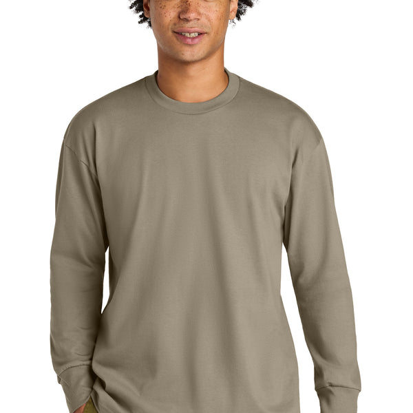 Next Level Apparel ®  Heavyweight Long Sleeve Tee NL7211 model wearing a comfortable long sleeve t-shirt in a neutral color.